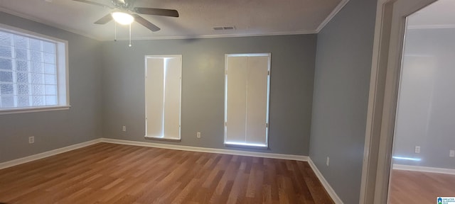 empty room featuring hardwood / wood-style floors, ceiling fan, and ornamental molding