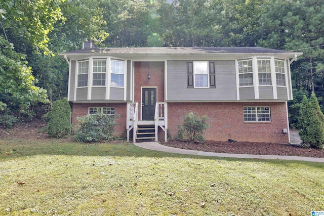 raised ranch featuring a front lawn