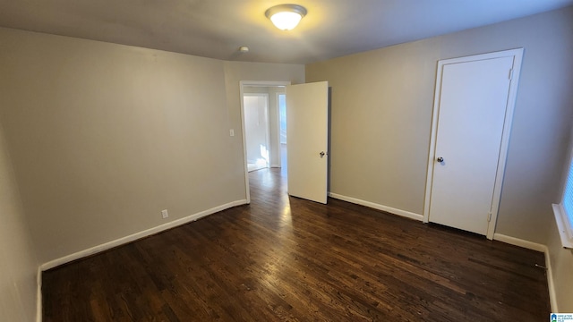 unfurnished room featuring dark wood-type flooring