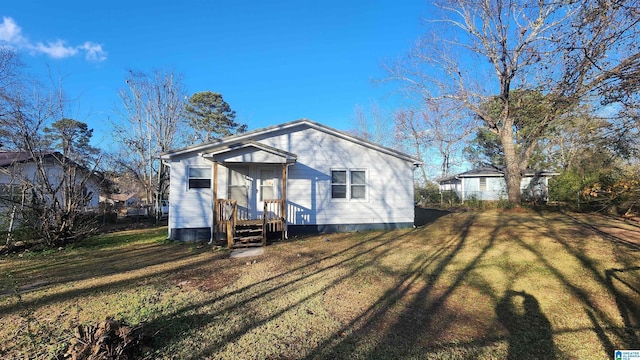 rear view of property with a yard