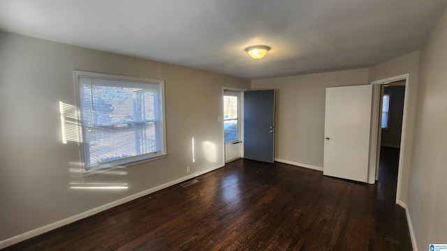 empty room featuring dark wood-type flooring