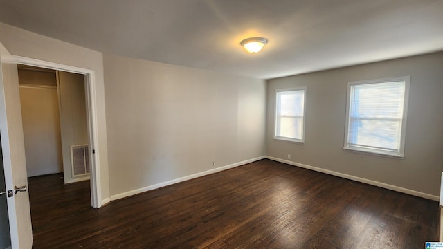 empty room with dark wood-type flooring