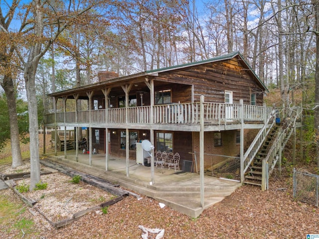 back of house featuring a patio area and a wooden deck