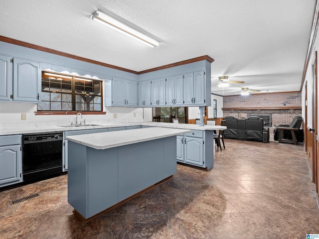 kitchen featuring dishwasher, sink, brick wall, a fireplace, and a kitchen island