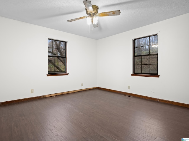 spare room with hardwood / wood-style flooring, ceiling fan, and a textured ceiling