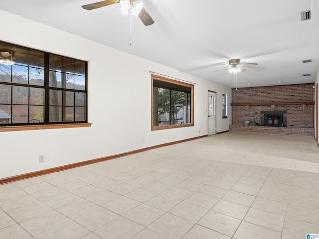 unfurnished living room featuring ceiling fan and light tile patterned floors