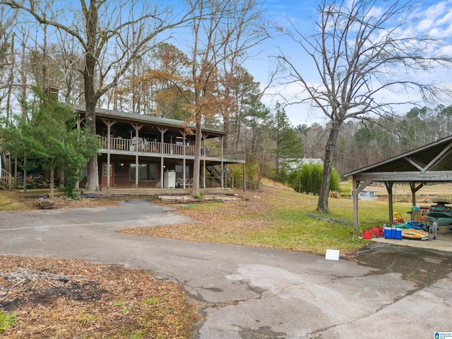 exterior space featuring a front yard, a porch, and a balcony