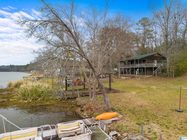 view of yard with a dock and a water view