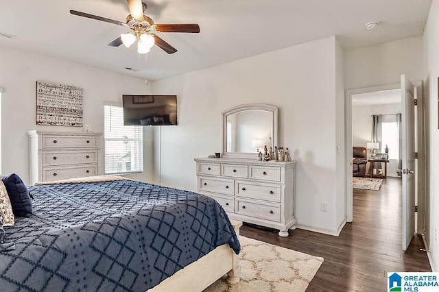 bedroom with ceiling fan and dark wood-type flooring