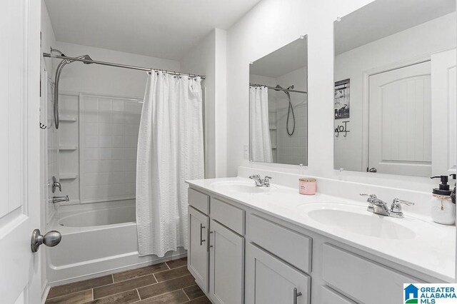 bathroom featuring shower / bath combo with shower curtain and vanity