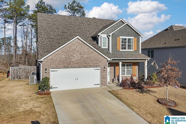 view of front facade with a front lawn, a garage, and central AC unit