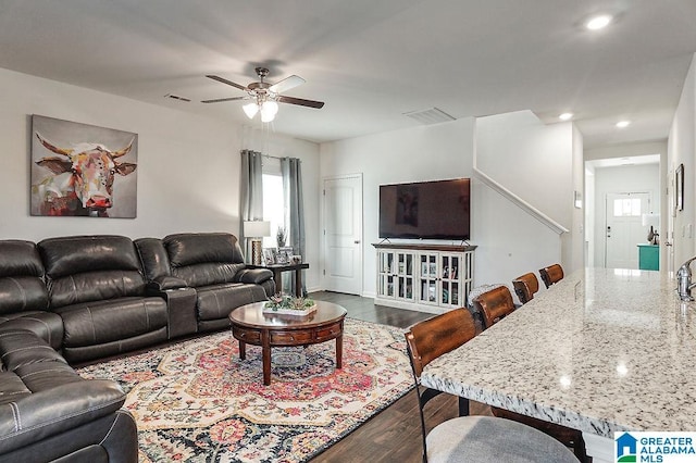 living room with hardwood / wood-style floors and ceiling fan