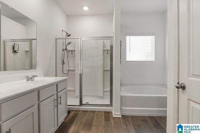 bathroom with vanity and separate shower and tub