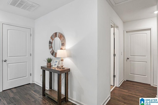 corridor with dark hardwood / wood-style flooring