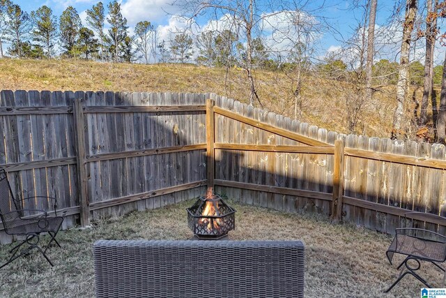 view of yard with a fire pit