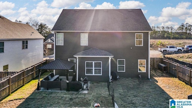 back of house with an outdoor hangout area and a yard