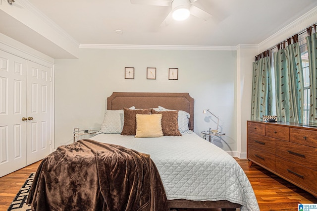 bedroom with crown molding, ceiling fan, a closet, and hardwood / wood-style floors