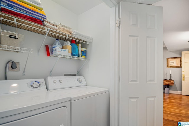 washroom featuring washer and clothes dryer and wood-type flooring