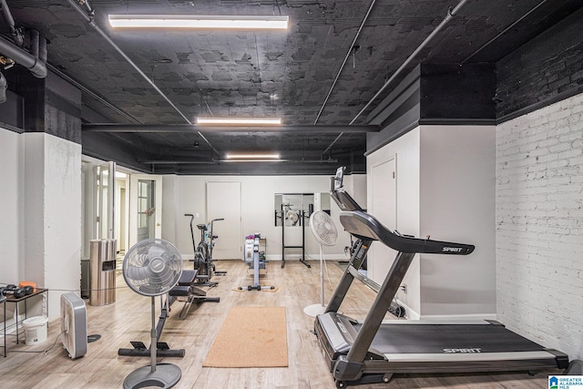 workout room with a high ceiling and hardwood / wood-style flooring