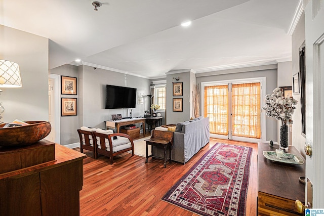 living room featuring french doors, ornamental molding, and hardwood / wood-style flooring