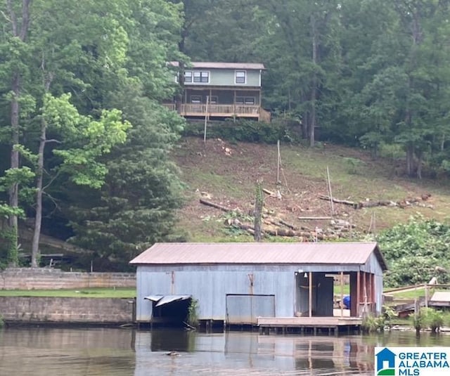 exterior space featuring a boat dock and a water view