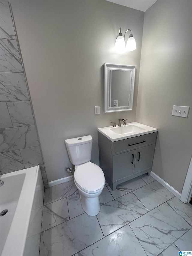 bathroom with vanity, a bathtub, and toilet