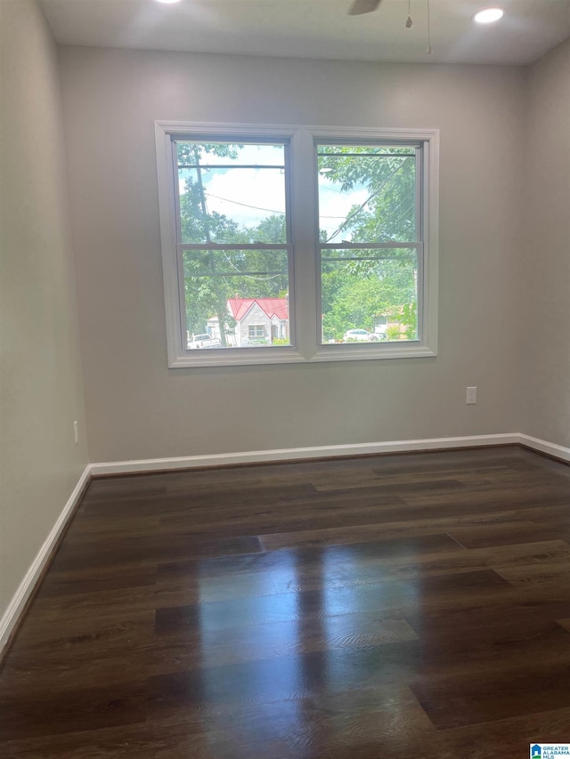 empty room featuring ceiling fan and dark hardwood / wood-style floors