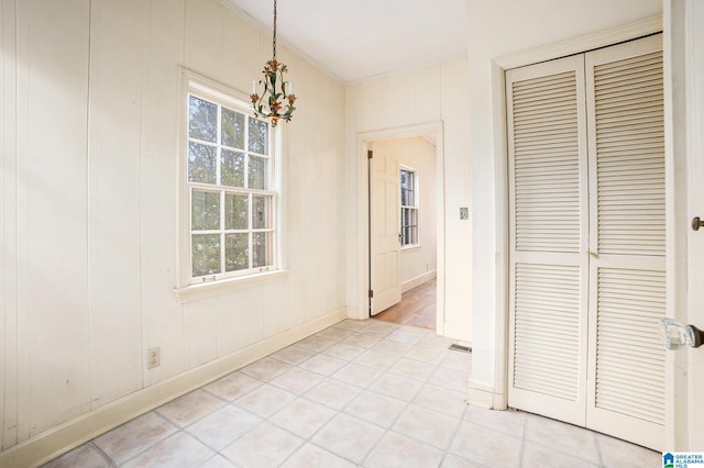 hall featuring a chandelier