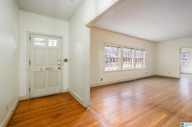 foyer entrance featuring a textured ceiling and hardwood / wood-style flooring