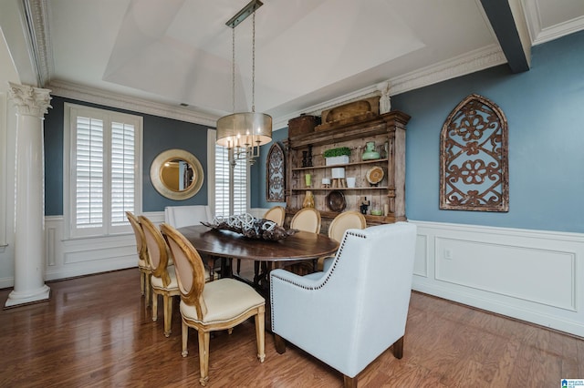 dining room with decorative columns, dark hardwood / wood-style flooring, an inviting chandelier, and ornamental molding