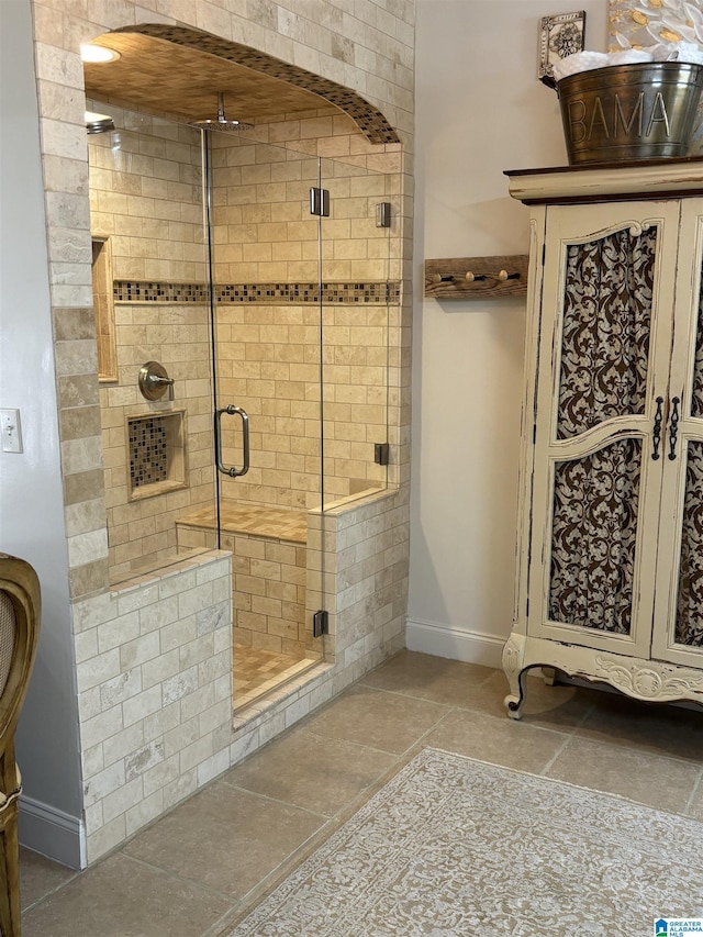 bathroom with a shower with door