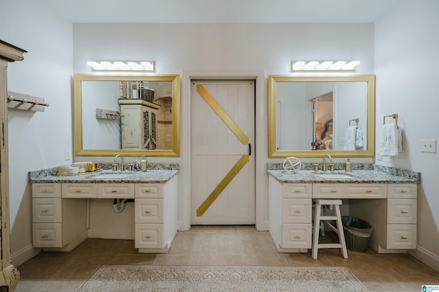 bathroom featuring tile patterned flooring and vanity