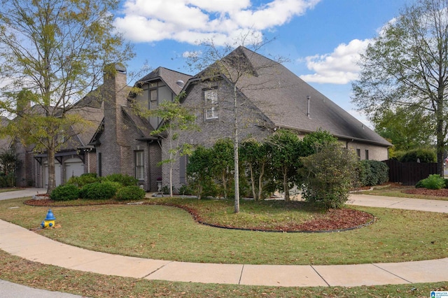 view of front of property featuring a front yard and a garage