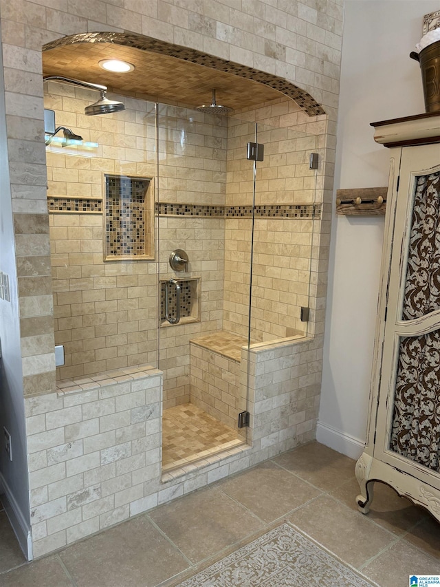 bathroom featuring a shower with shower door