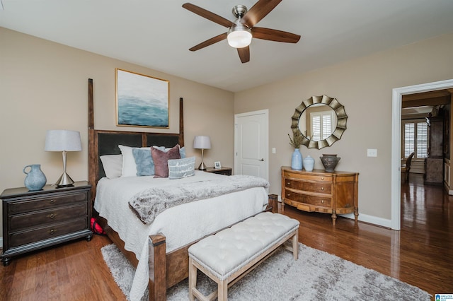 bedroom with dark hardwood / wood-style floors and ceiling fan