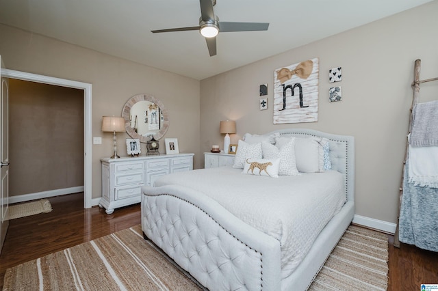 bedroom with dark hardwood / wood-style flooring and ceiling fan