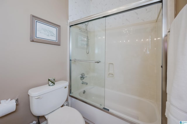 bathroom with shower / bath combination with glass door and toilet