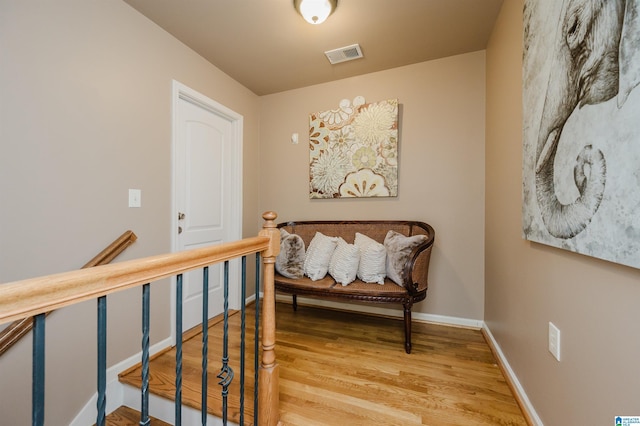 hall with hardwood / wood-style floors