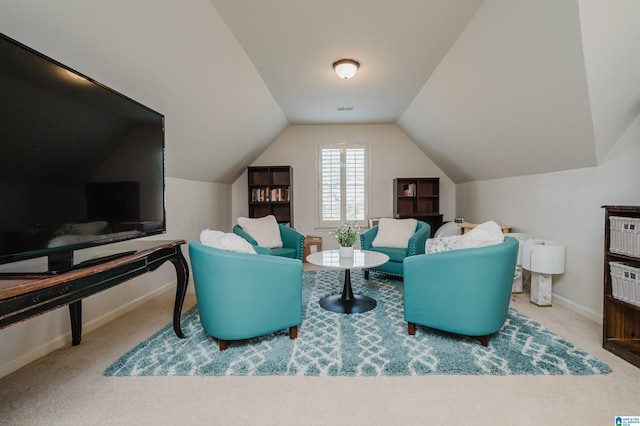 living area with carpet and vaulted ceiling