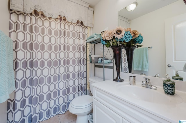 bathroom with walk in shower, tile patterned flooring, vanity, and toilet