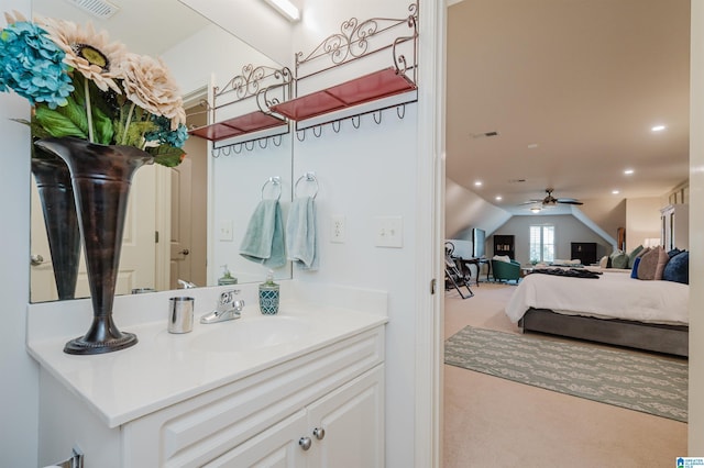 bathroom featuring ceiling fan, lofted ceiling, and vanity