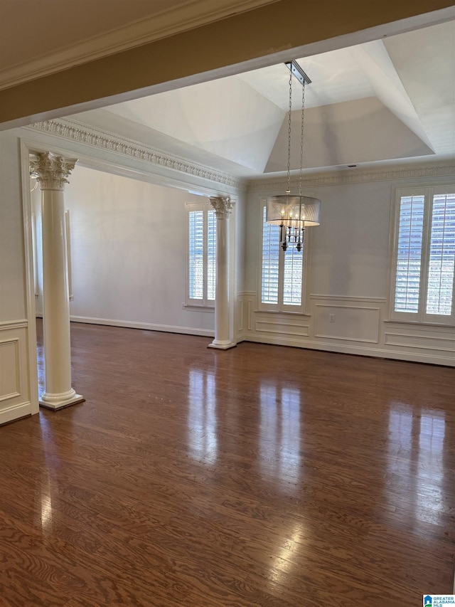 unfurnished dining area with a notable chandelier, ornate columns, and ornamental molding