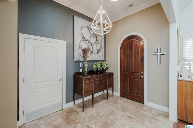 foyer with crown molding and a notable chandelier