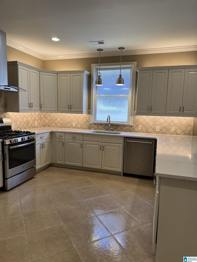 kitchen featuring appliances with stainless steel finishes, gray cabinets, wall chimney exhaust hood, and sink