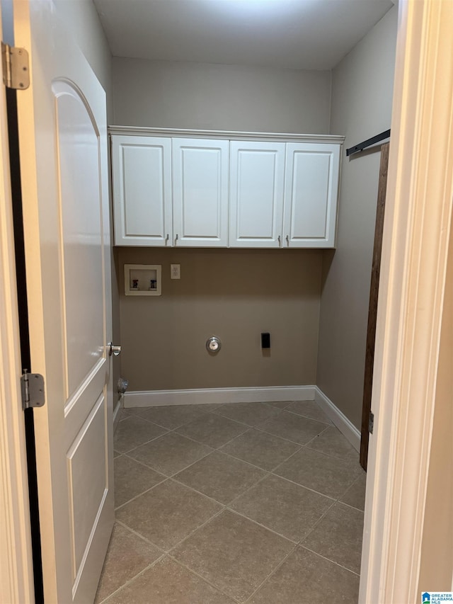 clothes washing area featuring cabinets, hookup for an electric dryer, gas dryer hookup, hookup for a washing machine, and light tile patterned floors