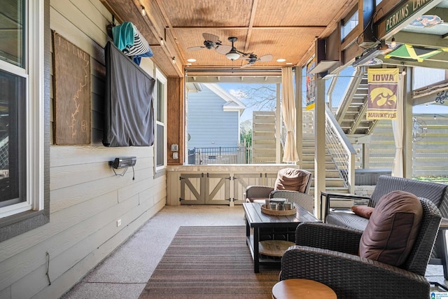 sunroom / solarium featuring ceiling fan and wooden ceiling