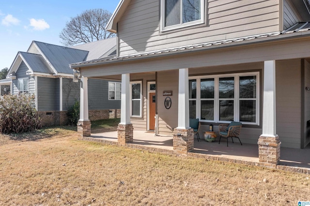 exterior space featuring a front lawn and covered porch