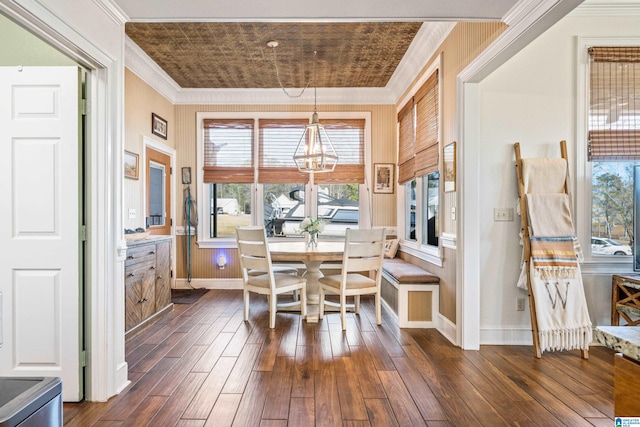 dining room featuring dark hardwood / wood-style floors, an inviting chandelier, and ornamental molding