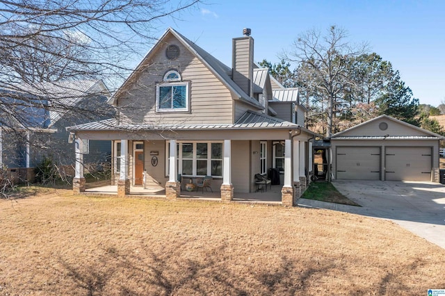 view of front of home featuring an outbuilding, a porch, and a garage