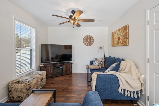 living room featuring ceiling fan and dark hardwood / wood-style floors